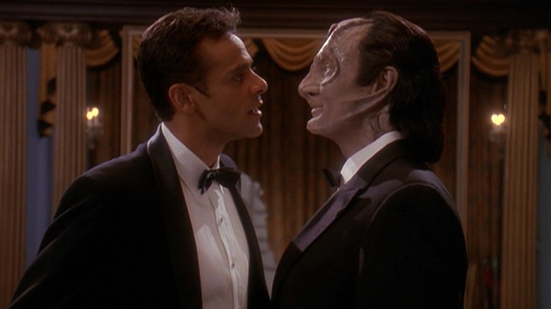 Alexander Siddig as Dr. Bashir and Andrew Robinson as Garak wearing tuxes and standing face-to-face on Star Trek: Deep Space Nine