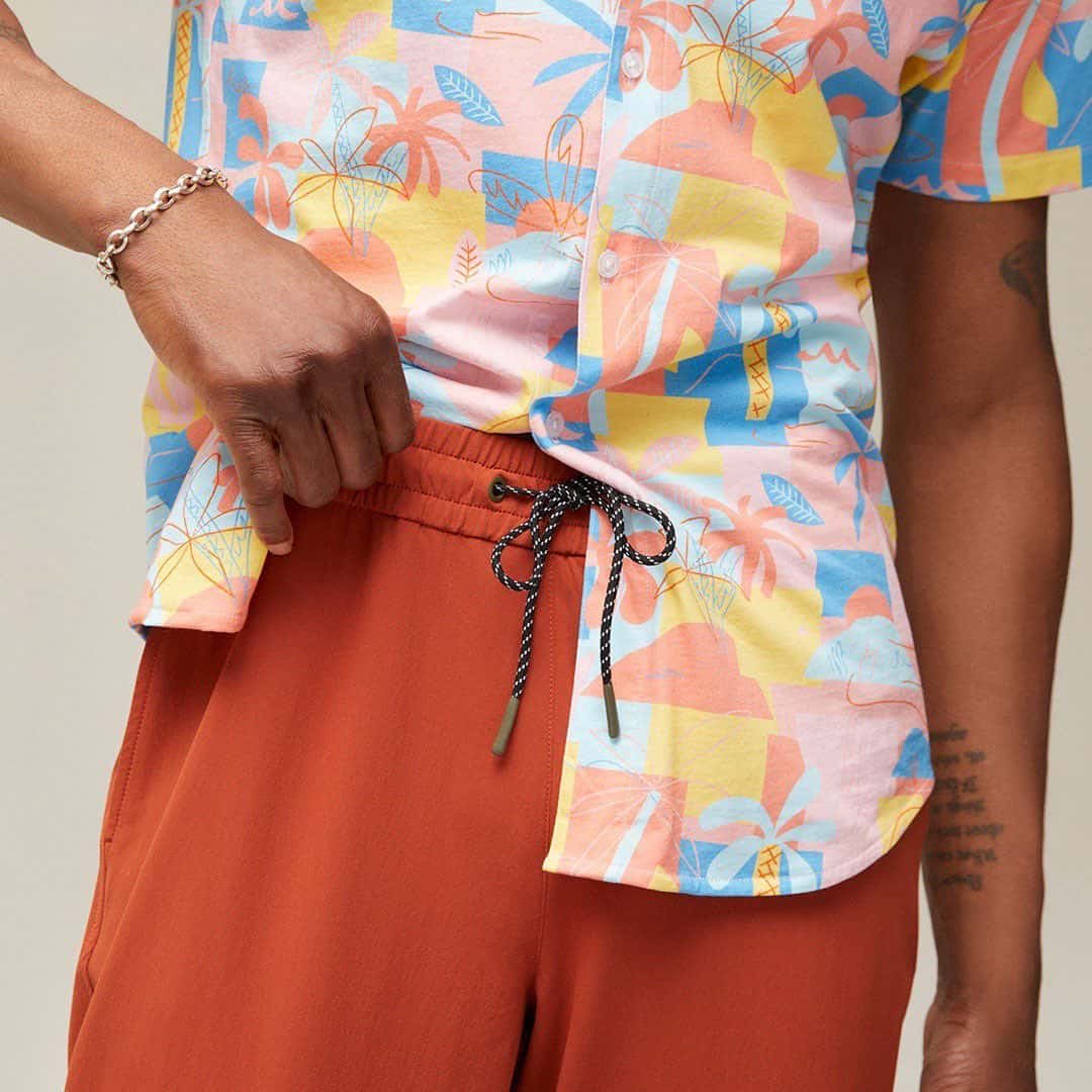 orange joggers paired with a colorful shirt